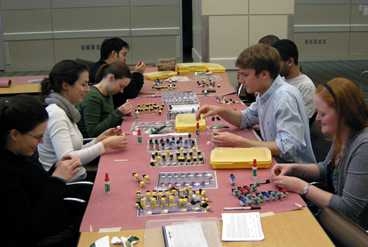 Eight MIT biological engineering graduate students volunteered for a three-hour shift on the evening of Jan. 20. They glued the amino acid side chain structures together for the LEGO protein kits.