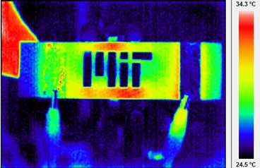 Infrared themographic image of a nanoengineered composite heated via electrical probes (clips can be seen at bottom of image). The scalebar of colors is degrees Celsius. The MIT logo has been machined into the composite, and the hot and cool spots around the logo are caused by the thermal-electrical interactions of the resistive heating and the logo "damage" to the composite. The enhanced thermogr...