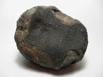 One of the thousands of fragments recovered from the Allende meteorite, which fell in Mexico in 1969. The black area is a fusion crust, produced from the heat of slamming into Earth's atmosphere. New studies of one such fragment provided evidence that the object the meteorite originated from had a magnetic field.