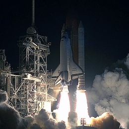 The space shuttle lifts off in December, 1993, with Hoffman aboard, for the first mission to repair the Hubble Space Telescope.