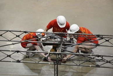Team members assemble the bridge at the national Student Steel Bridge Competition.