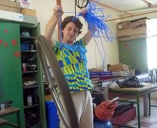 Anna Waldman-Brown demonstrates hands-on science using a bicycle gyroscope at Takorardi Technical Institute.