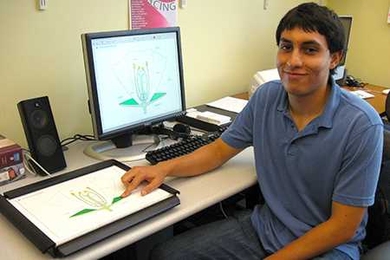 Jorge A Ornelas, an MIT undergraduate working in ATIC, points to an encoded image on the IVEO tablet.