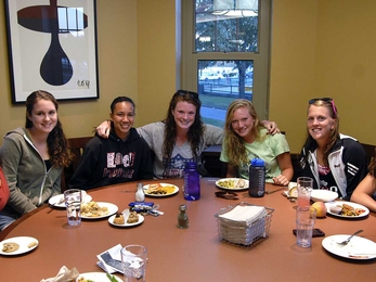 From left, members of the women's soccer team eat in the South dining room with views of the Charles River and Boston skyline: Valerie Andersen '15, Jessica Ong '15, Kaithlyn Nealon '14, Samantha Fleischmann '14 and Meghan Wright '13.