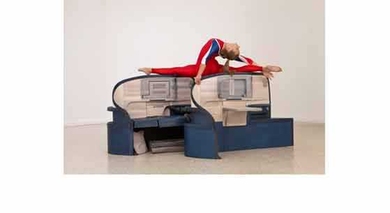 As part of the installation, gymnasts perform routines on wood replicas of business class seats from Delta and American Airlines. "We are playing with simple associations," Allora told <i>The Guardian</i> – "the relation between air travel and the way nations project themselves; the way air travel is bound up in notions of class, comfort, leisure, business. Airlines say a lot about culture and n...