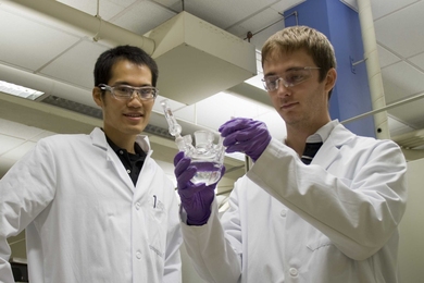 Materials Science and Engineering Graduate Student Jin Suntivich (left) and Mechanical Engineering Graduate Student Kevin J. May (right) inspecting the electrochemical cell for oxygen evolution reaction experiment.