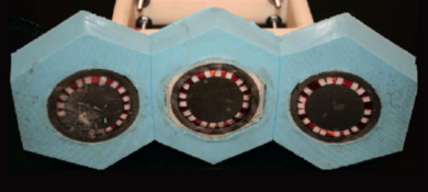 Based on simulations, the researchers have developed a manufacturing technique that can combine multiple modules as shown above. Here, three modules are mounted on a base of silicon rubber. The overall unit bends freely, so it can conform and adhere tightly to a curved surface such as the outside of a pipe. Despite their proximity, the three modules operate independently with no interference.