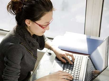 Woman typing on a laptop