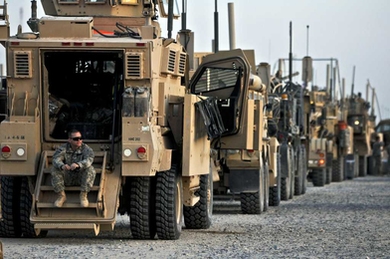 U.S. Army soldier with the 82nd Airborne Division surveys the area while crossing the Khabari border from Iraq into Kuwait on Dec. 9.