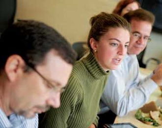 Junior Alix de Monts, center, chair of the Undergraduate Association (UA) Sustainability Committee and undergraduate representative on the Campus Energy Task Force, provides an update on the UA's spring 2011 exchange of 1,000 compact-fluorescent light bulbs for incandescent bulbs in student dorms.