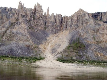 The Siberian Traps were created about 250 million years ago by massive volcanic eruptions. The lava that covered the land formed flat plains as it cooled. Over the millennia, weathering has caused the rock to crack and wear, forming steep mountains. Some rock resists weathering, creating spires of rock. 