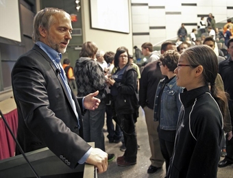 Richard Garriott speaks with a student at the 2011 Zero Robotics Challenge.