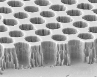 A microscope image of the tungsten photonic crystal structure reveals the precise uniform spacing of cavities formed in the material, which are tuned to specific wavelengths of light.