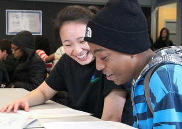 Jane He tutoring Emmanuel DeBarros in critical reading during the Sunday Sessions of Amphibious Achievement.