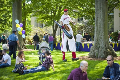 A stilt-walker dressed in a Red Sox uniform traveled through Killian Court.