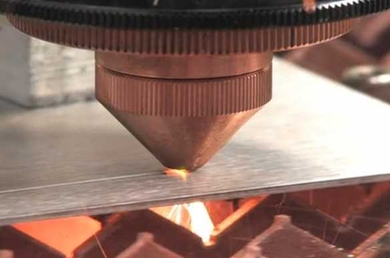 The wavelength beam-combining diode laser is shown cutting through several millimeters of steel. A small spot size combined with high intensity provides high-speed cuts through thick materials with minimal impairment to the width of the cut. 
