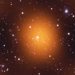 Microwave (orange), optical (red, green, blue) and ultraviolet (blue) image of the Phoenix Cluster.