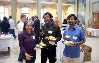 A few postdocs socialize during an event in Walker Memorial.