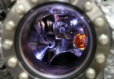 A solid-state lithium-air battery (highlighted in orange) is positioned inside a test chamber at the Advanced Light Source (ALS) at Lawrence Berkeley National Laboratory, in preparation for its testing using X-ray photoelectron microscopy.