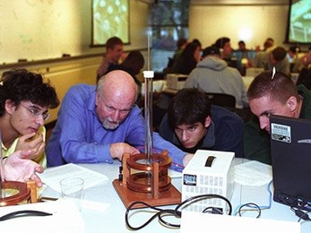 Professor John Belcher (second from left), one of the principal investigators for the Technology Enabled Active Learning (TEAL) Program, interacts with students in TEAL lab.