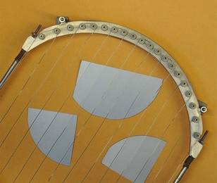 Pieces of a silicon wafer (in gray), used for solar cells or computer chips, can be coated or "passivated" using a vapor deposition process, in which the wires shown here are heated to vaporize polymer materials which then are deposited to coat the surface.