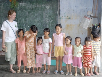 Laura Chirot poses with rural kindergarten children in central Vietnam.