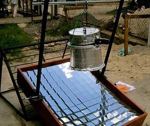 The SolarClave system at work. The sterilizing vessel is an ordinary pressure cooker that has been insulated on the top and sides.