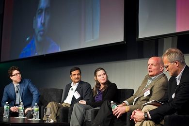 Khan Academy founder Sal Khan, who was videoconferenced in, loomed above a panel consisting of, from left to right, moderator Jonathan Zittrain, a professor at Harvard Law School; Anant Agarwal, president of edX; Daphne Koller, a co-founder of Coursera; Stephen Hodownes, CEO of Southern New Hampshire University's online college; and Bror Saxberg, chief learning officer at Kaplan, Inc.