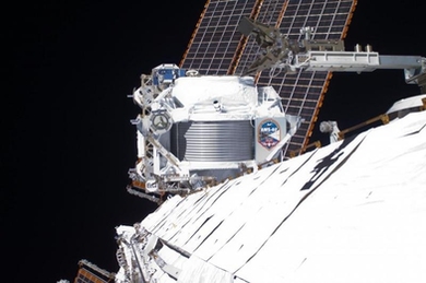 From its vantage point on the International Space Station approximately 260 miles above the Earth, the Alpha Magnetic Spectrometer (AMS) collects data from primordial cosmic rays that traverse the detector.