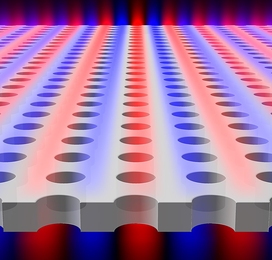 Light is found to be confined within a planar slab with periodic array of holes, although the light is theoretically &#34;allowed&#34; to escape. Blue and red colors indicate surfaces of equal electric field.