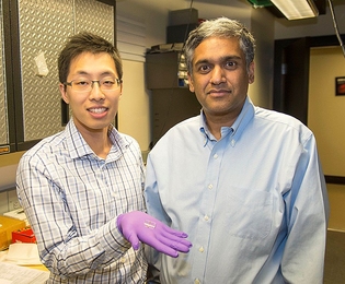 From left: Sungjae Ha and Anantha Chandrakasan demonstrate the chip in the Nanomechanics Laboratory.