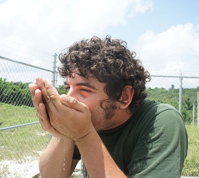 A Mexican member of the team takes the first sip of the purified water produced by the system.