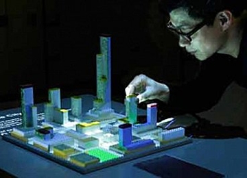 The CityScope tool uses an array of HD video projectors and 3D mapping to visualize a wide range of urban simulations, from flows of data to human behavior, by projecting them onto physical models.