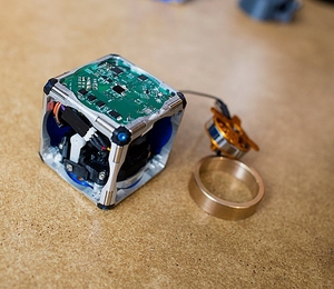 A prototype of a new modular robot, with its innards exposed and its
flywheel &#8212; which gives it the ability to move independently &#8212; pulled out.