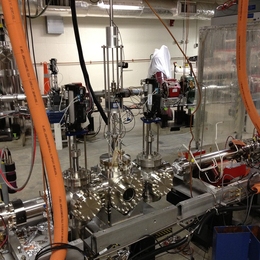 Photo shows a prototype device designed by the MIT team to produce a very narrow, high-powered beam of electrons for an experiment called DarkLight. The device was tested at the Jefferson National Accelerator Facility to confirm that it could meet the requirements needed to detect a hypothesized particle based on one theory about the nature of dark matter.
