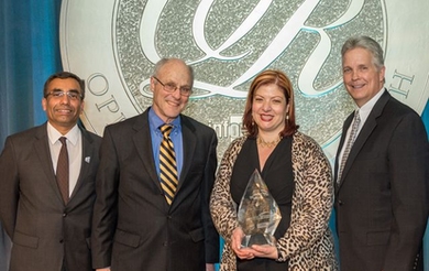 MIT LGO’s Georgia Perakis holds the UPS George D. Smith Prize trophy, alongside LGO program director Don Rosenfield (to her right). With them are Ranganath Nuggehalli, chair of the 2014 UPS George D. Smith Prize Committee (far left), and Randy Stashick, global vice president of engineering for UPS (far right).