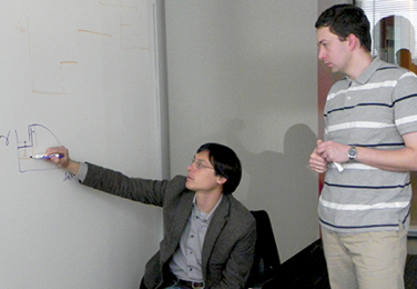 Collaborators, Jeff Gore (left) of MIT and Kirill Korolev of Boston University discuss joint research into range expansions. They suggest applying ecological and evolutionary lessons from dynamics of microbial populations to treating human cancers in a paper co-authored with Joao B. Xavier of the Memorial Sloan-Kettering Cancer Center. 