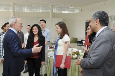 MIT President L. Rafael Reif, left, mingled with the SuperUROP students at the year-end reception for nearly 80 SuperUROP graduates in celebration of their completion of the Advanced Undergraduate Research Opportunities Program in EECS. EECS Department Head and creator of SuperUROP Anantha Chandrakasan is standing on the right.