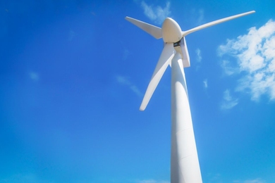 White wind turbine against a blue sky