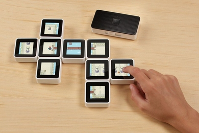 Among the games designed for the Sifteo Cubes were adventure games, like the one shown here, where users uncover sections of a maze for characters by moving cubes up and down, and putting them adjacent to each other.