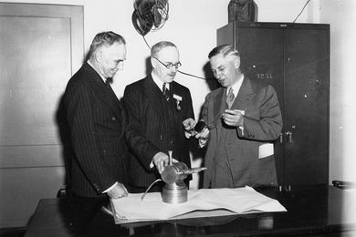 Henry Thomas Tizard (center), British physicist and head of the Tizard Mission, visits with MIT researchers. The 1940 Tizard Mission introduced to the U.S. the newly invented resonant-cavity magnetron and other British radar developments, and helped establish MIT as a major federally funded research university.