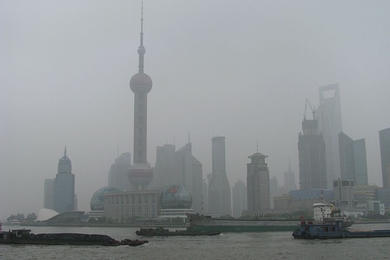 Coal barges head upstream on the Huangpu River in Shanghai. 