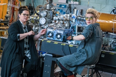 Abby Yates (Melissa McCarthy, left), a gung-ho scientist with expertise in the paranormal, and Jillian Holtzmann (Kate McKinnon, right), an eccentric engineer, tinker in a nearly perfect replication of an MIT lab.