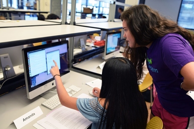 MIT Women's Technology Program tutor Katherine Ward '16 works on a programming exercise with a student.