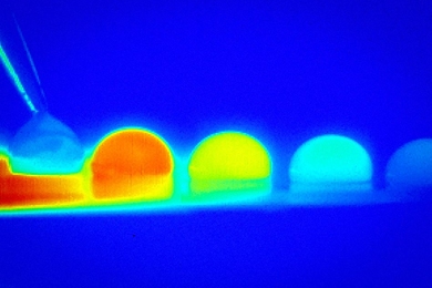 In a time-lapse sequence, infrared imaging shows the temperature changes within a droplet of water as it moves across a treated silicon surface in response to temperature differences on that surface.
