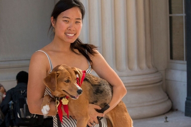 Graduate student Stephanie Ku holds her dog, Wingnut, at an MIT Puppy Lab event on an unusually warm October afternoon. Ku is founder of the Puppy Lab, which launched in May as part of MIT's MindHandHeart Initiative.