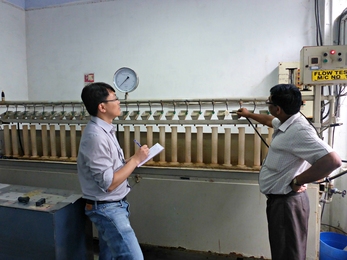 Ruo-Qian Wang (left) worked with engineers at Jain Irrigation Systems in Jalgaon, India, to understand the design requirements for high-efficiency irrigation technology.