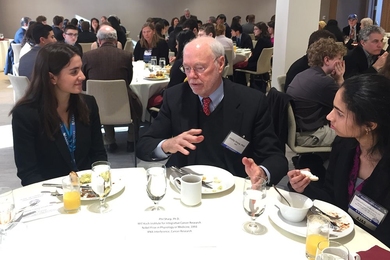 AJAS attendees Jessica Frank (left) and Sriharshita Musunuri (right) chat with MIT Professor Phillip Sharp, former AAAS president and Nobel laureate. 