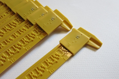 Plastic sliding calipers known as Squirrel Devices, developed by MIT grad students, make geometry’s continuous shapes and lengths measurable for blind and limited-vision students, who can read measurements in Braille.