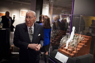 MIT Professor Ernesto Blanco stands next to a model of his invention, the stair-climbing wheelchair, during the 2011 MIT 150 kickoff celebration at the MIT Museum.   